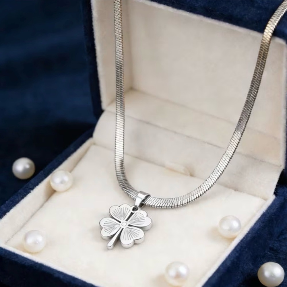 silver-toned fashion necklace four-leaf clover pendant on a flat snake chain.